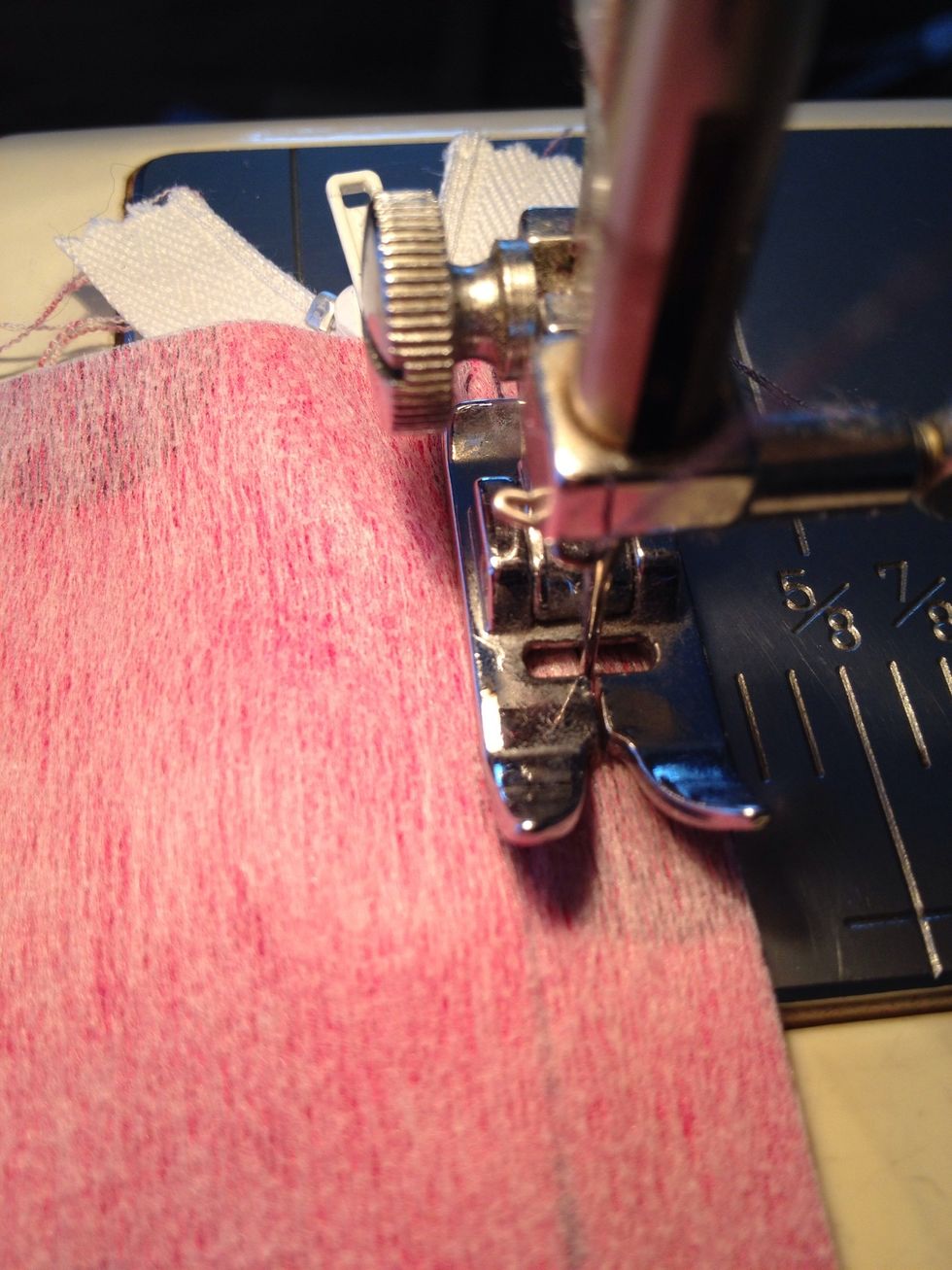 Once you get your seam going, stop sewing but leaving your needle in the fabric. Raise your presser foot and gently zip the zipper back up and continue.