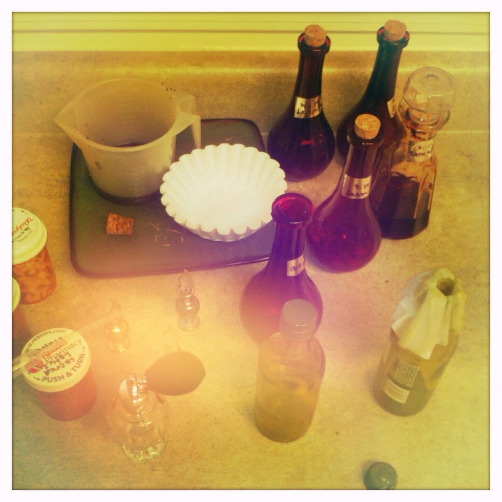 Once you get your tinctures out, get out the measuring cup with the spout, coffee filters, dropper, glass cup and bowl, perfume bottles, smaller glass bottles, and also get out the herbs you used.