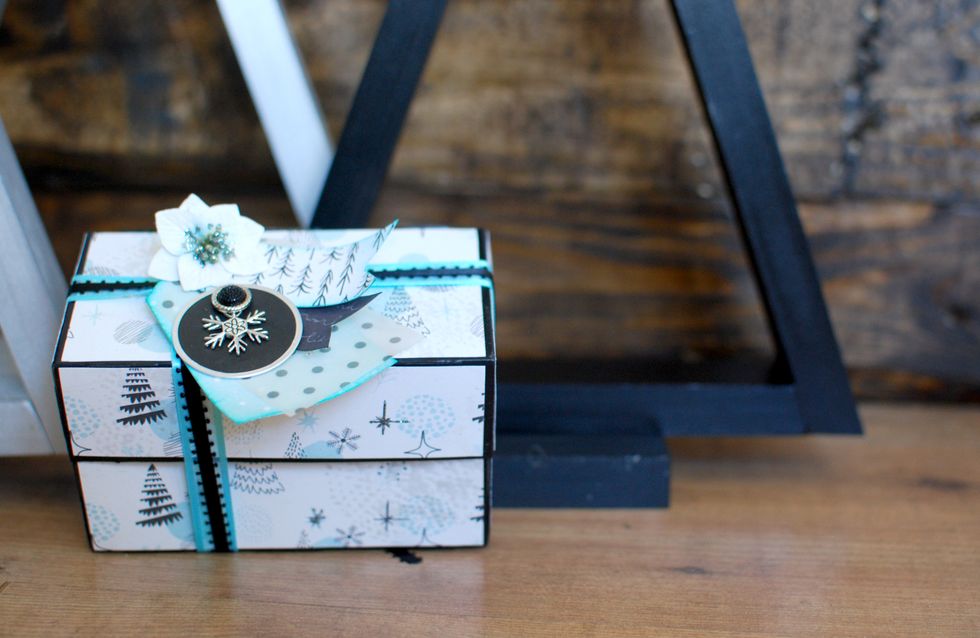 Once you have all of this put together, using the hot glue, secure the flower over the hole of the paper tag and flags. You can either tie the tag on, or hot glue it to the top of the box.