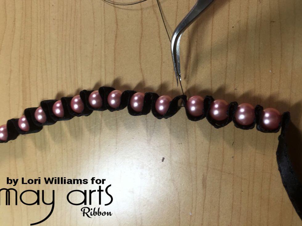 Once you have all your beads set, then run back through the ribbon and the beads with your needle and thread. This will help to make sure the bracelet stay tight and secure the beads/pearls.