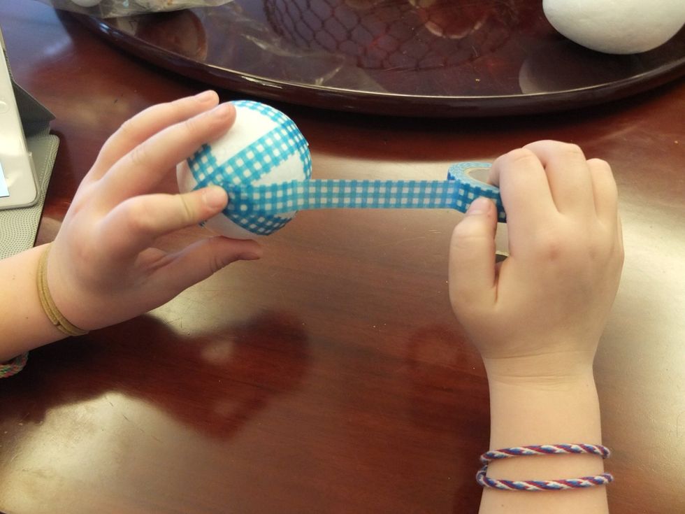 Once you have covered a good portion of the ball you will want to press down the tape so that there aren't large gaps. The best method is by rolling the ball around in your palms. Don't push too hard.