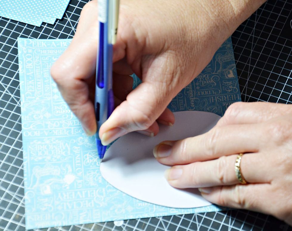 Once you have created a template in the shape of an egg you will need to trace around it 12 times on your choice of patterned paper.