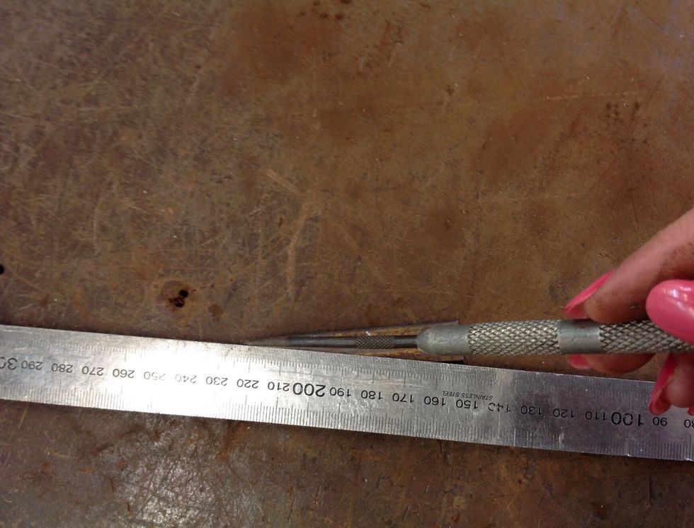 Once you have cut off the foot, to find the centre use a metal ruler and scribe, draw lines from corner to corner. Now once you've found the centre use the centre punch to make an indent in the centre