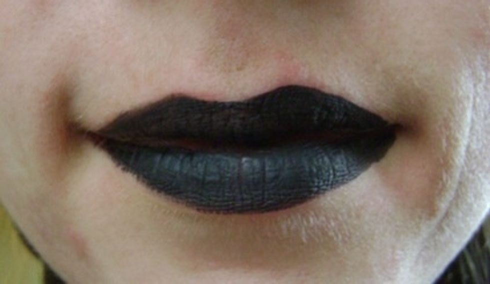 Once you have done both sides of your face, paint your lips black.