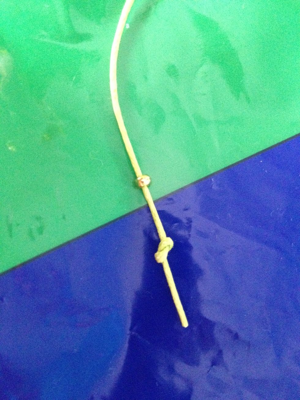 Once you have finished threading through the beads, tie a knot at the end of each string. (this will make your life so much easier, believe me!)