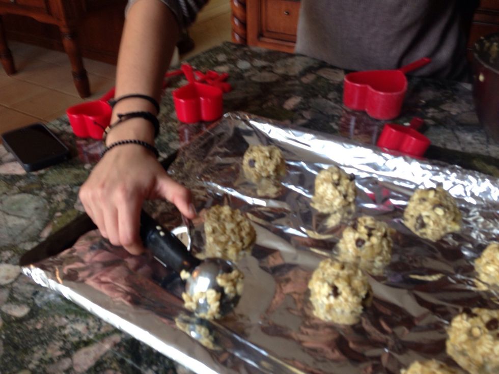 Once you have folded all of the ingredients scoop out the mixture and place them on a lightly greased cookie tray