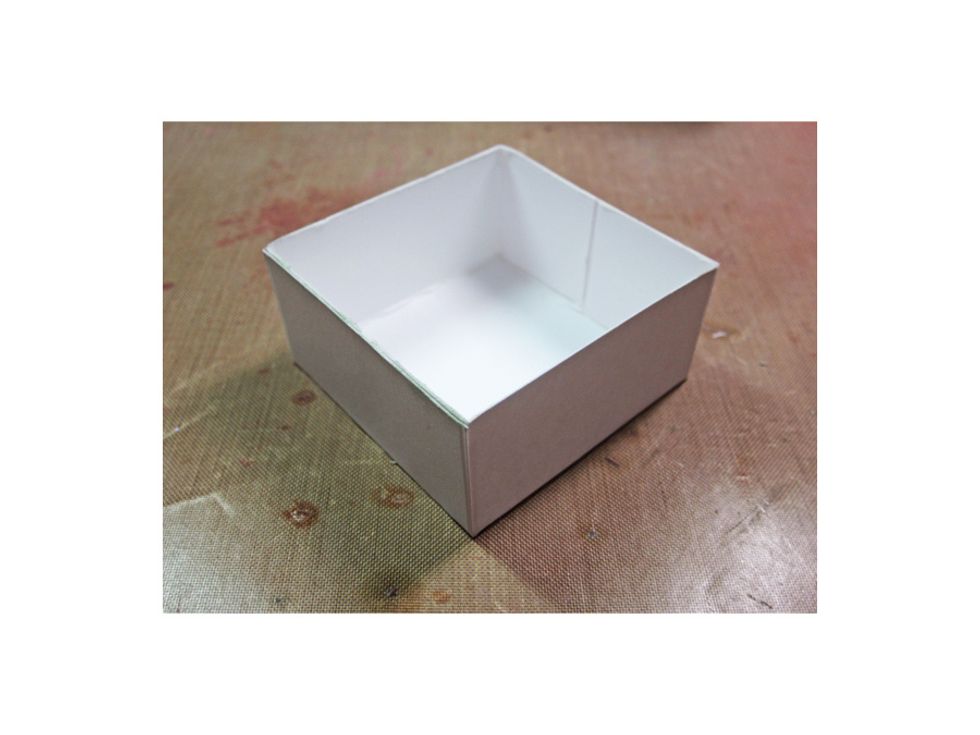 Once you have glued the tabs down you've created one of the little drawers. Repeat this on the three remaining squares.