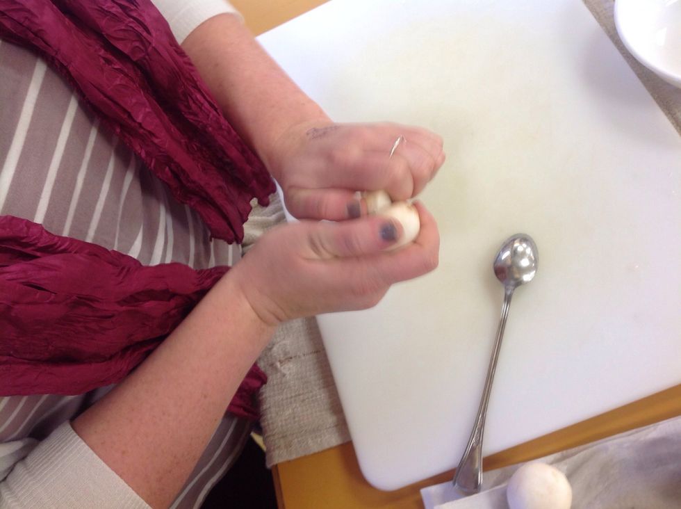 Once you have gone around the stem with the spoon use your hands to take out the stem. Use your spoon to carve out a little of the bottom of the mushroom to give you more space for the filling.