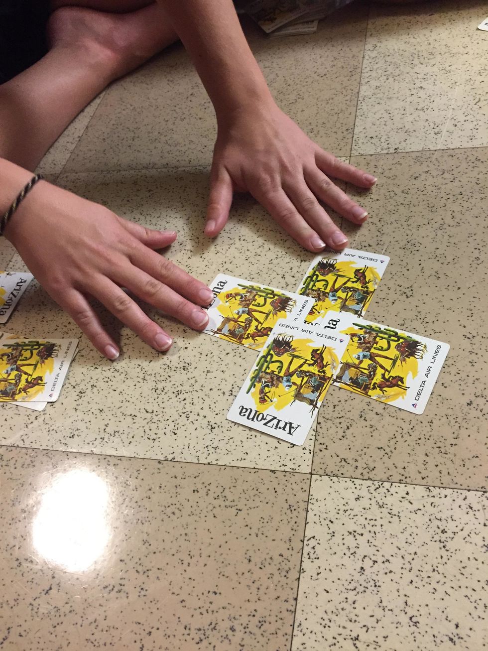 Once you have it down to one pile, ask the participant to select 2 cards. If they select their card, discard the other 2 cards not selected.