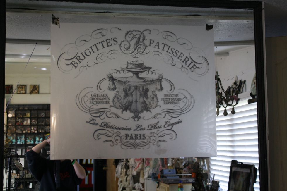 Once you have it in place, remove the backing so you can start to transfer your image! I just peeled back from one corner underneath, making sure not to push my decor transfer onto the mirror yet.