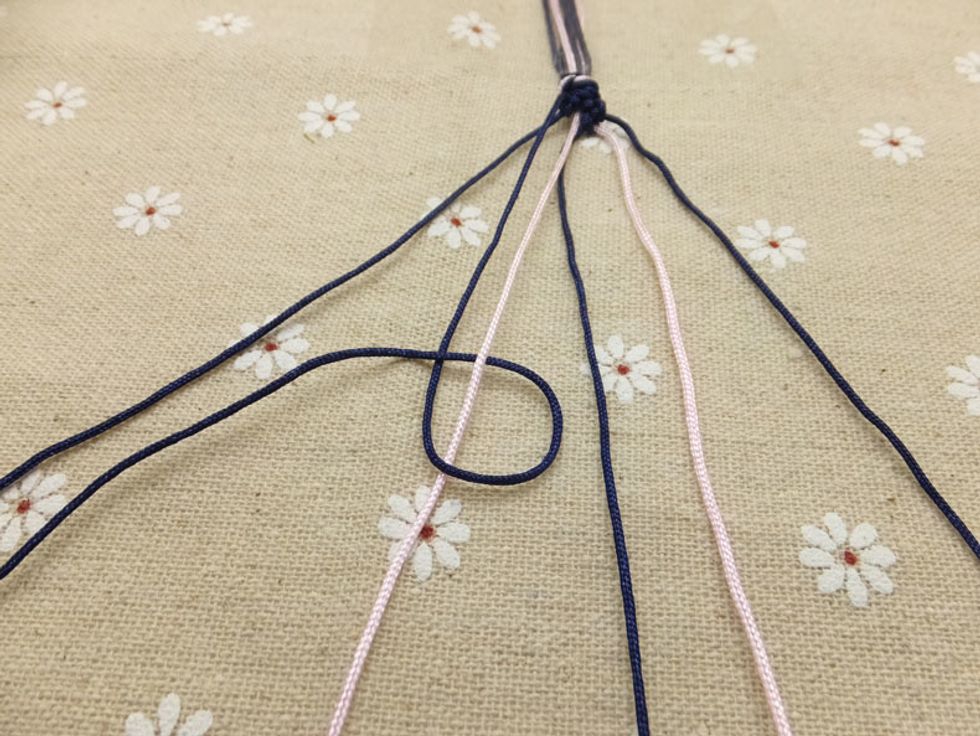 Once you have knotted the outer left cord to the one next to it, do the same to the next cord closer to the middle.