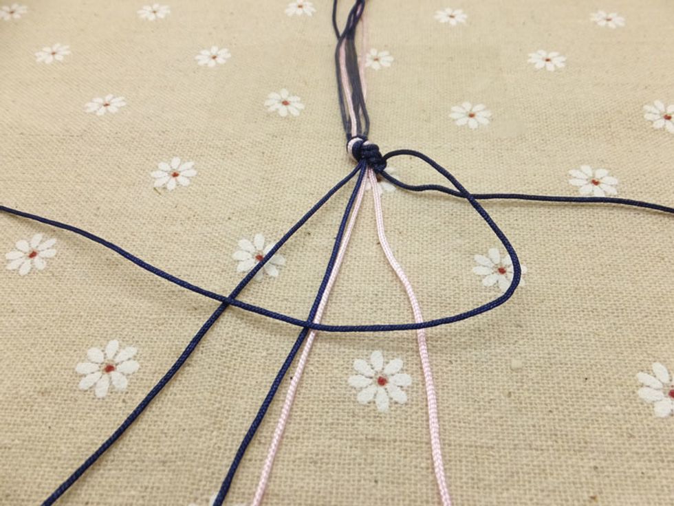 Once you have knotted the outer right cord to the one next to it, do the same to the next cord closer to the middle.