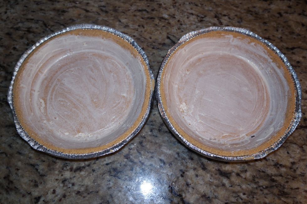 Once you have mixed the ingredients completely, you will rub butter onto the cookie. Rub until the whole cookie is covered in butter. Do this to both plates of cookies.