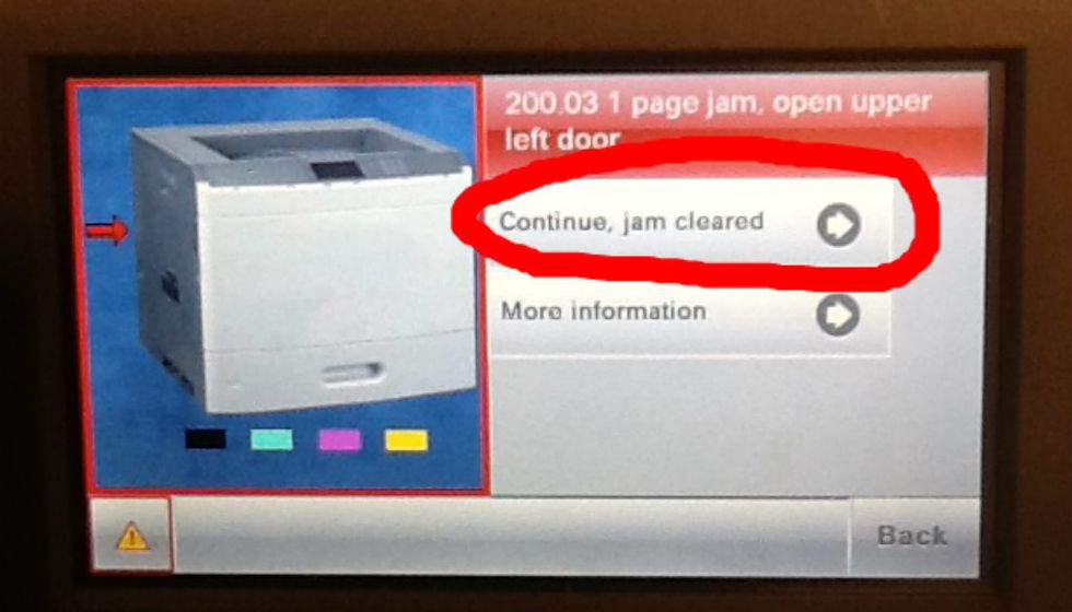 Once you have opened and cleared the paper jam, press continue to "reset" the printer.
