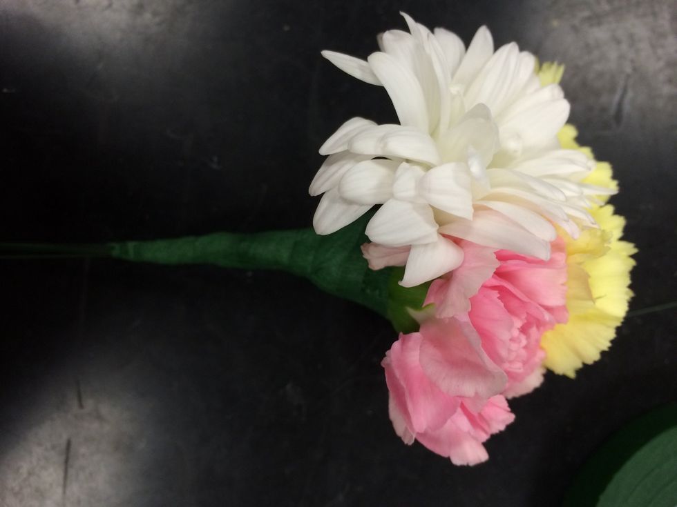 once you have placed them how you like, tape all three flowers together.