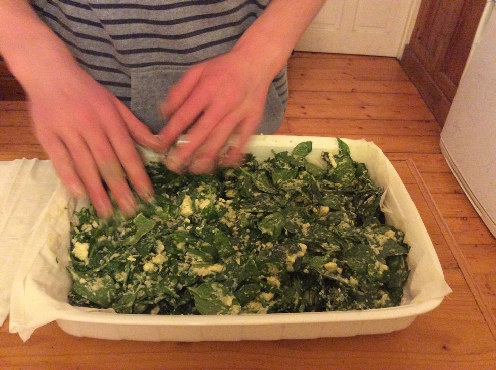 Once you have poured the mixture into the dish, level it out with your hands or an icing spreader, to ensure it cooks evenly.
