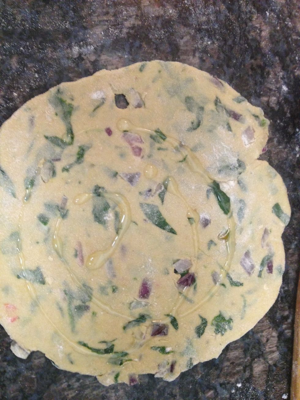 Once you have rolled it a little drizzle little oil and spread