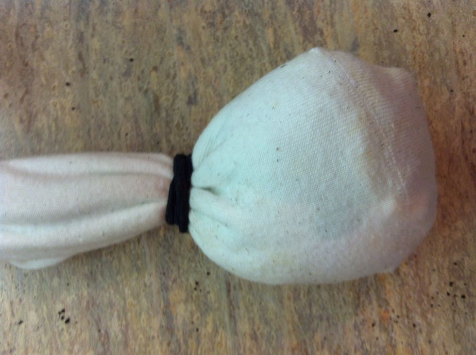 Once you have the desired amount in, tie it off with the elastic band