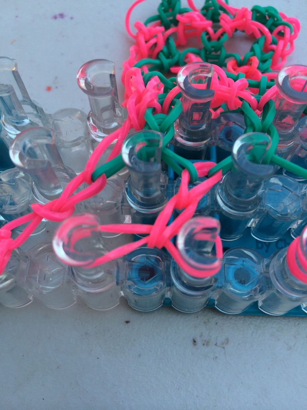 Once you have the length that you want it's time to combine the bands together. Take one side of the rubber bands from each set of pegs and move it to the other one.