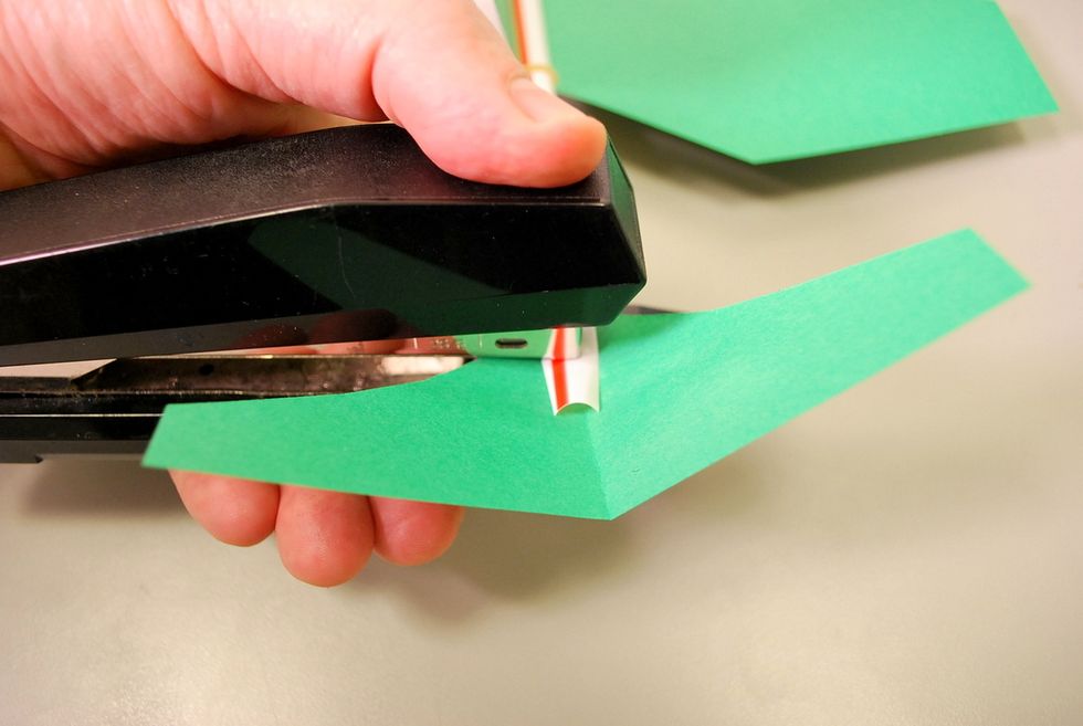 Once you have the tail in place, staple it through the straw end