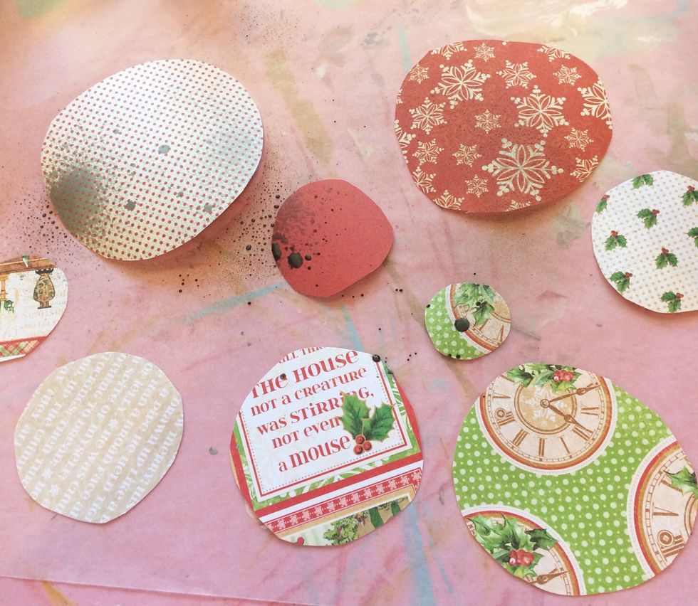 Once you have them all done, choose either a plain water bottle or a colored spray ink (like I did) to lightly mist your circles. This will help the next step.