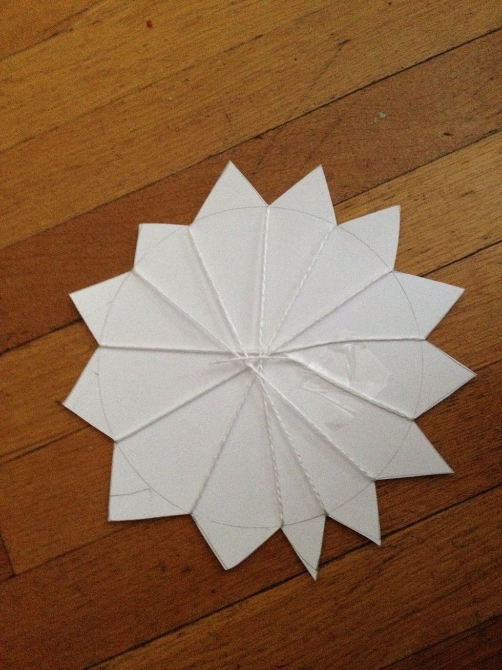 Once you have wrapped the yarn around all the petals, tape your loose end to the back.