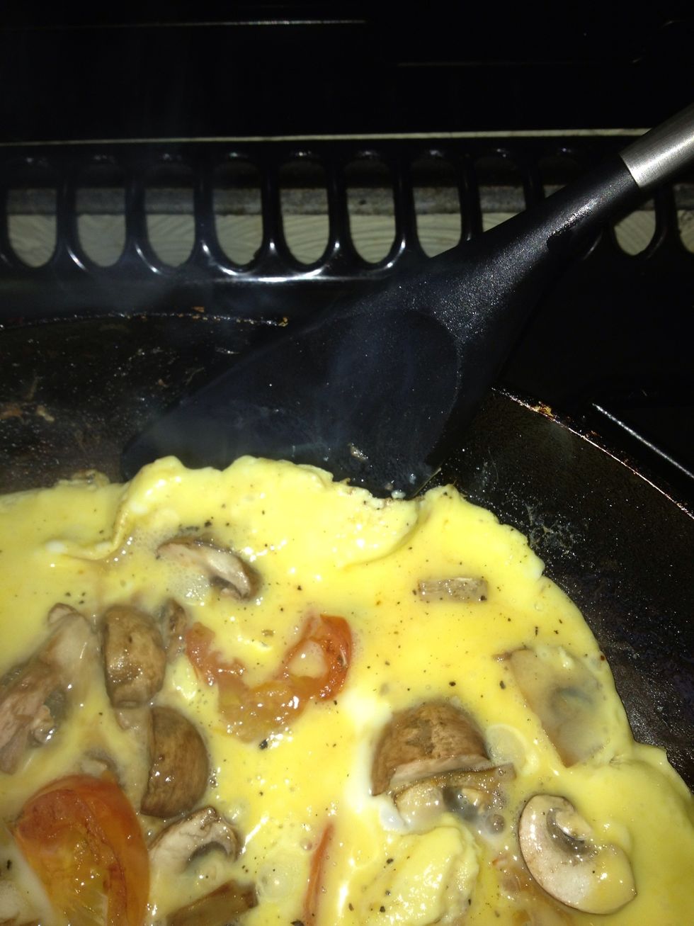 Once you notice the egg starting to look cooked, take your spatula and loosen around the edges like this being careful not to break it up...