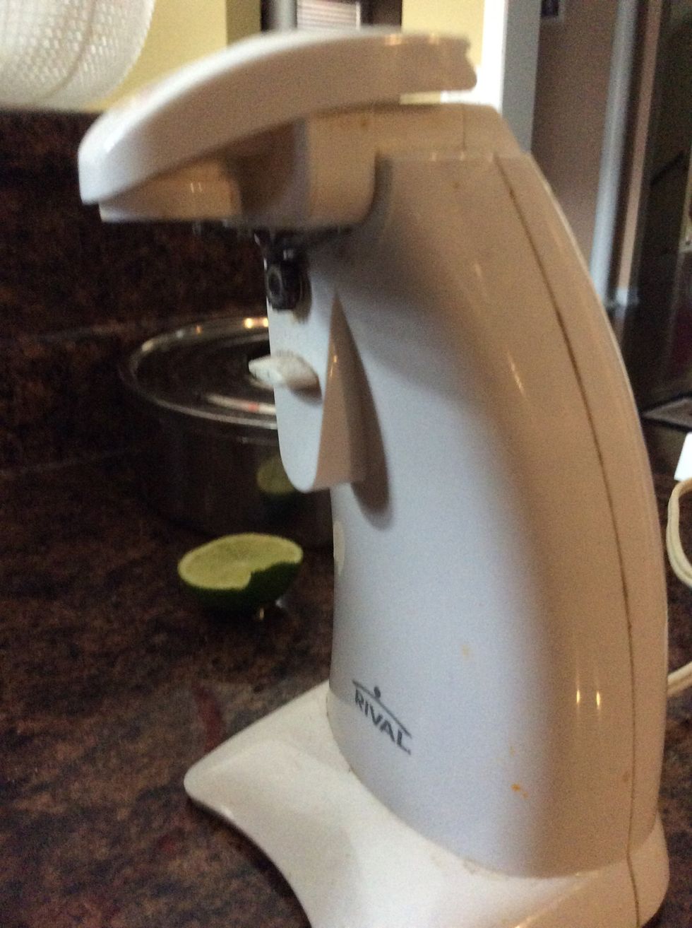 Once you placed your carrot chips in the oven, you will start to prepare for the hummus dip. Using your can opener, open your can of chick peas.