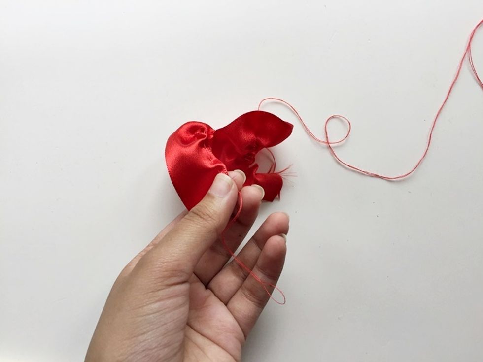 Once you're done stitching, pull the open ends of the stitched thread to create ruffle on the ribbon.