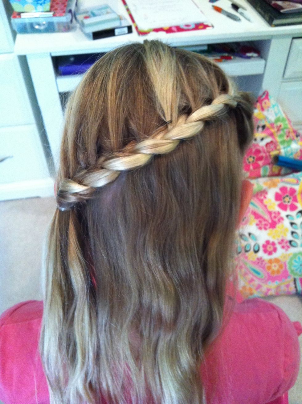 Once you reach the other side of the head tie off the braid with a clear elastic or keep braiding so a braid falls down on the shoulder.