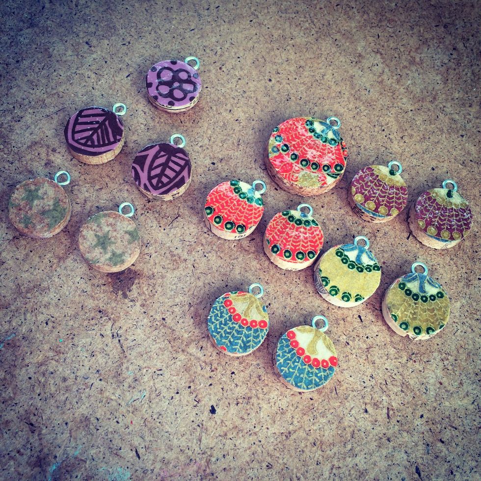 Once you've applied the wood varnish and it's dry, add the screw-in eyelets to the top of the cork round.