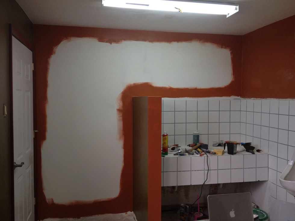 Once you've edged (aka "cut-in") the edges of the wall and smoothed it all out,, use a roller to fill in the center.