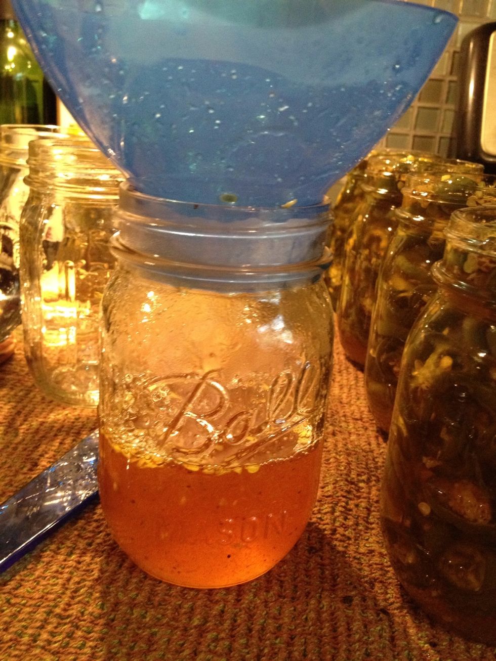 Once you've filled each jar, there will be leftover syrup in the pot. Fill an empty mason jar with this syrup as this can be used for basting meats or as a salad dressing.