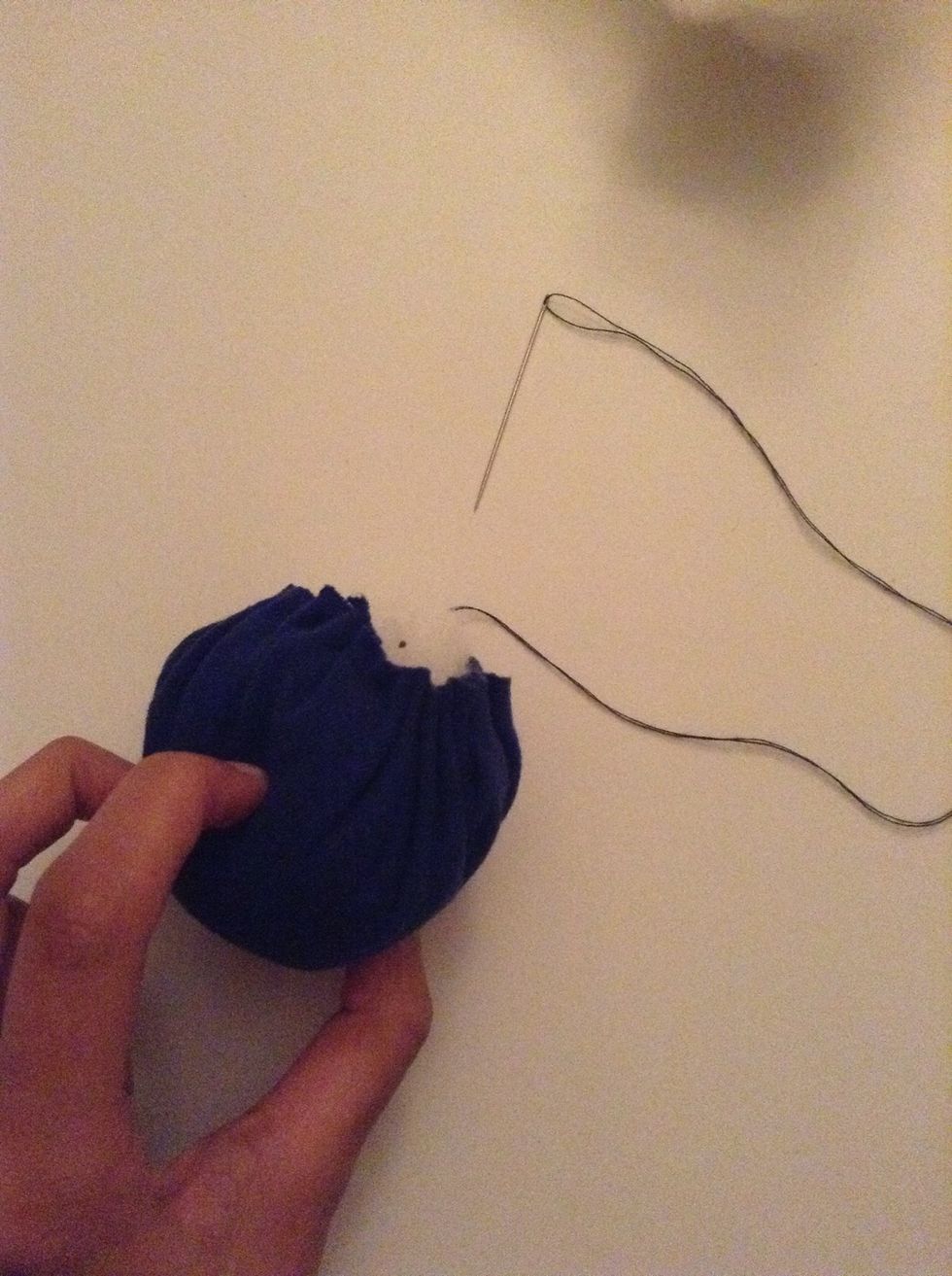 Once you've filled your pouch with stuffing, tighten and secure the pouch. Make sure to stitch over the ends as much as you can if you want this to be durable.
