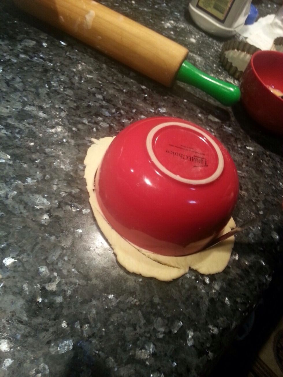 Once you've finished rolling out your dough, place a round bowl over your piece of dough and cut around it to form a circle