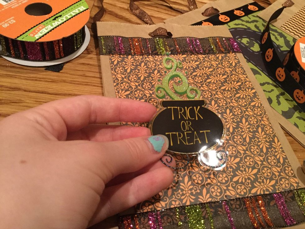 Once you've finished you can embellish your bags with ribbon and Halloween stickers.