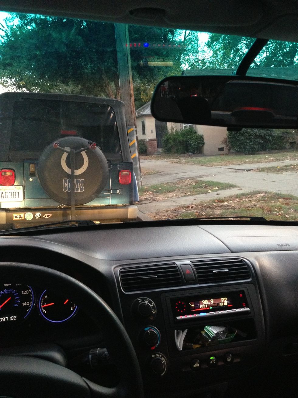 Once you've gone as far back as you can go, straighten your wheels out and advance forward slowly until the bottom of the target car's back tires are barely visible over the hood of your car.