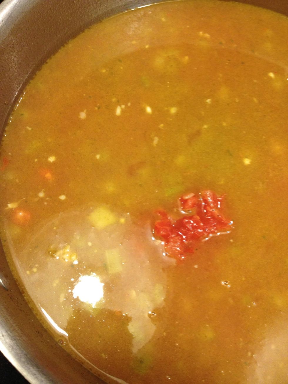 Once you've let the stock merry with the chicken and veggies, add a large can of tomato paste and the largest size can of petite diced tomatoes. I buy the kind that has onion added.