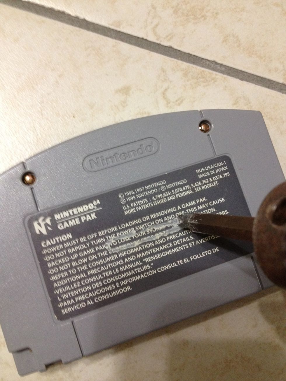 Once you've marked the cartridge, take the power drill and make holes on either side of the marking.