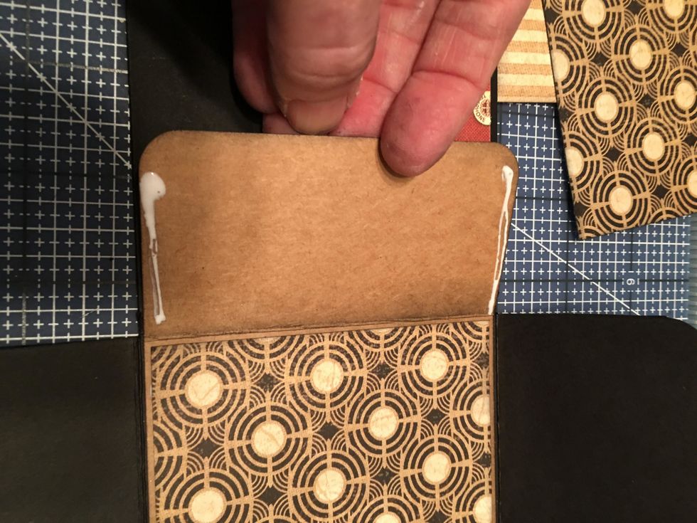 Once you've patterned the inside center section on the tag, you can create a pocket with the remaining part of the tag. Put glue on just the sides and attach it down onto the patterned section.