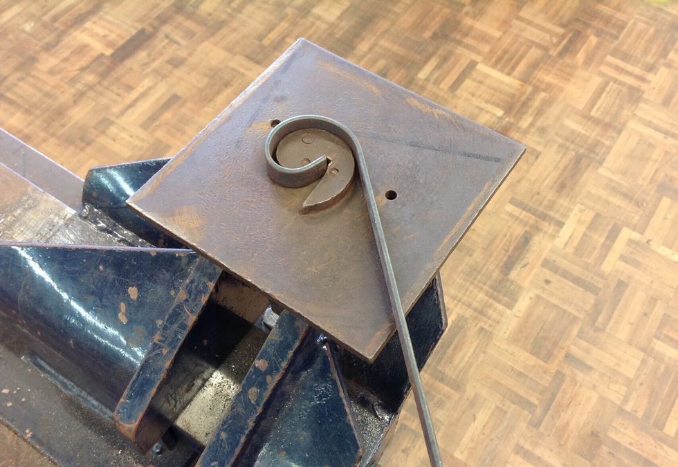 Once you've placed your flatbar in the gap begin to bend the flatbar around the scroll until you have a curl.