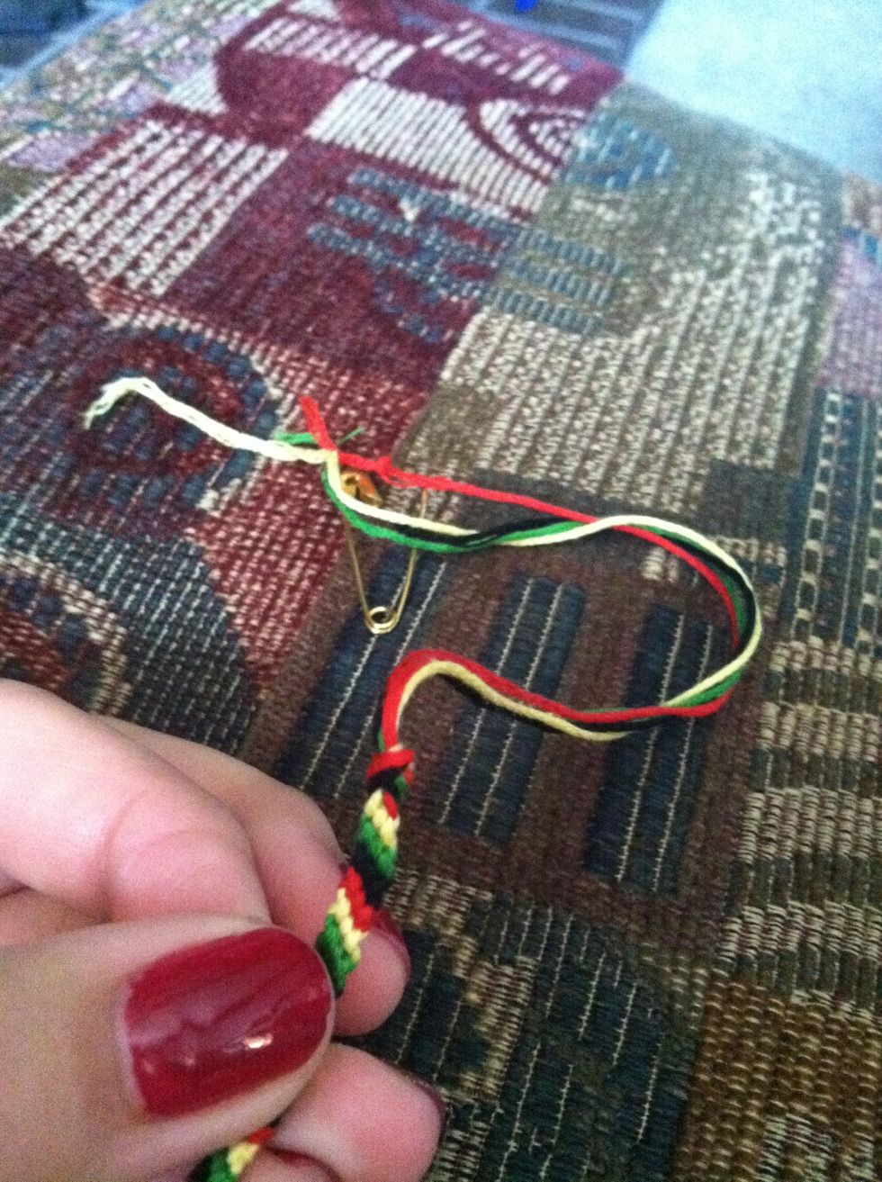 Once you've reached your desired length, double knot the ends, just as you did in Step 3. Trim the leftover strands, leaving about 1 to 2 inches, and remove your safety pin.