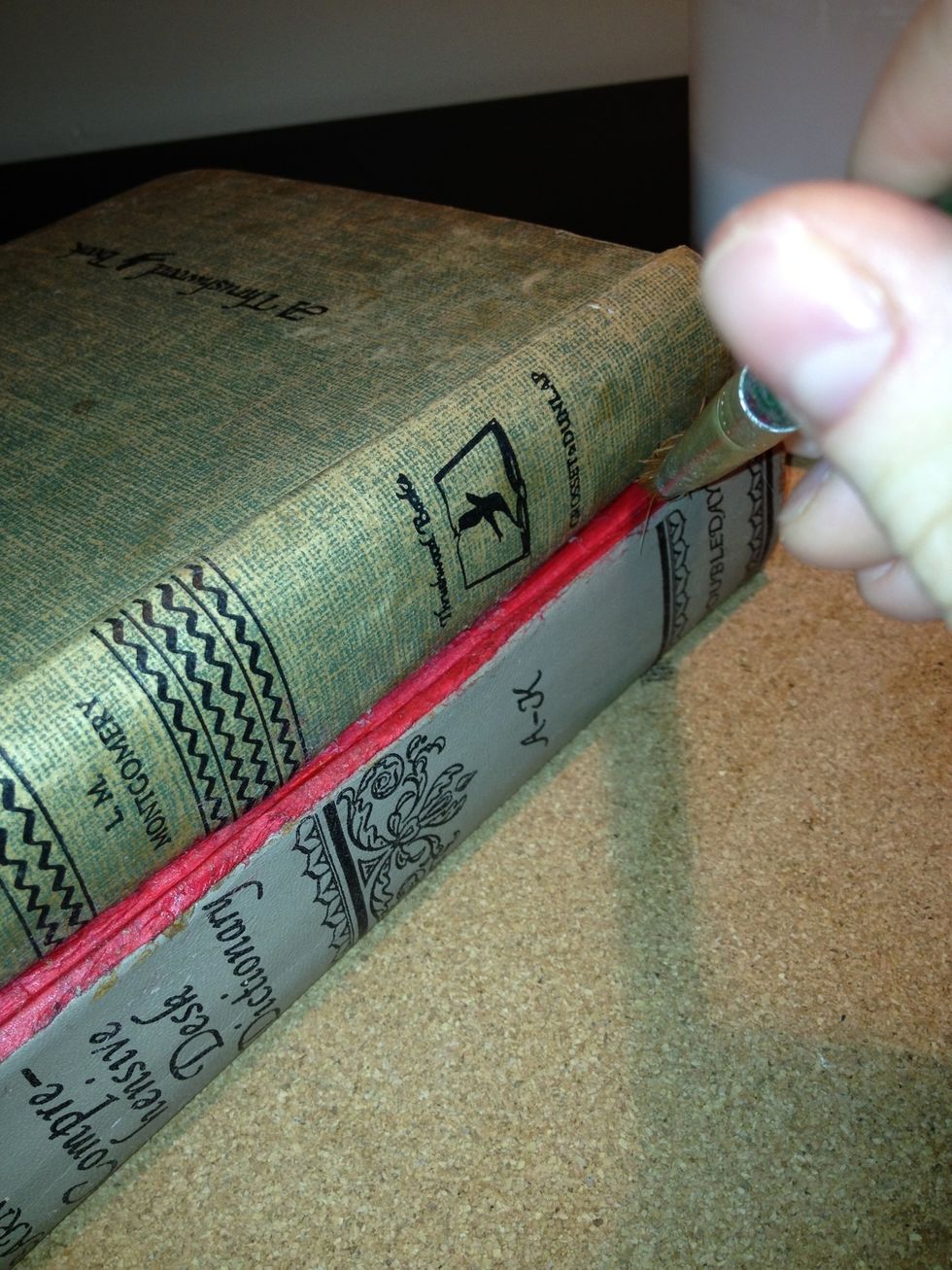 Once you've removed all pages from your books, you may place them on top of one another. Use glue to hold them in place.