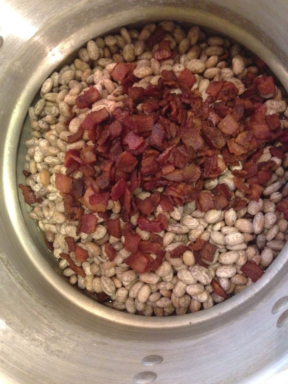Once your beans have steeped in your boiled water for an hour, been strained, and returned to a rinsed pot, add your rendered bacon.