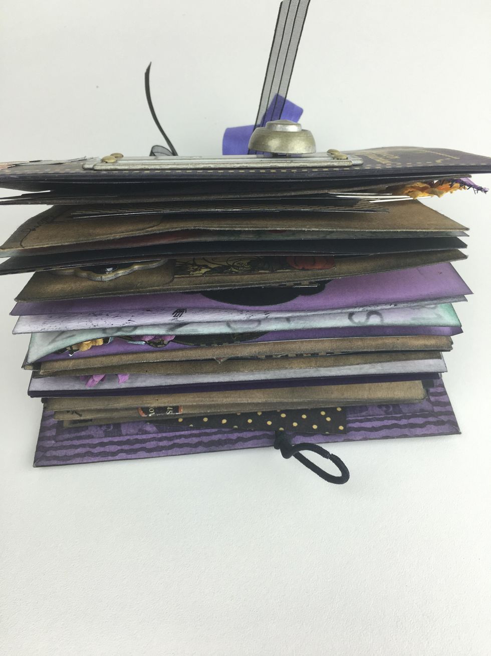 Once your book is filled with tags, pockets, paper clips, photos and notes, it will become chunky and the elastic over the door knob will help keep it closed.