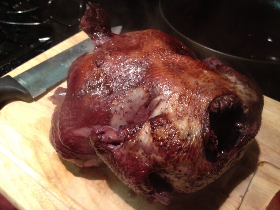 Once your chicken has been aside for a few minutes, it's time to quarter it.