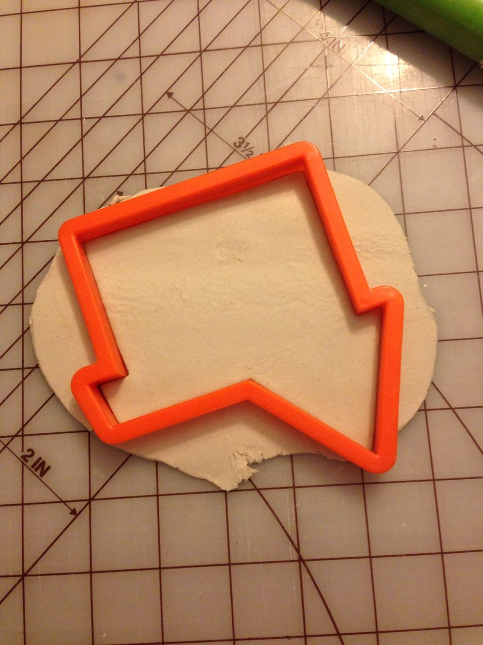 Once your clay is rolled to an even thickness, place your cookie cutter as such and press down. It's often best to remove the excess while the cutter is down to give a clean edge.