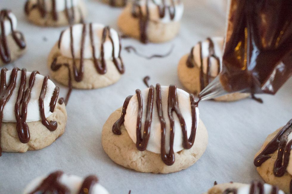 Once your cookies are done baking, remove from oven and drizzle your melted chocolate over the cookies. Allow the melted chocolate to cool before serving (it gets sticky!). And voila! You are done!