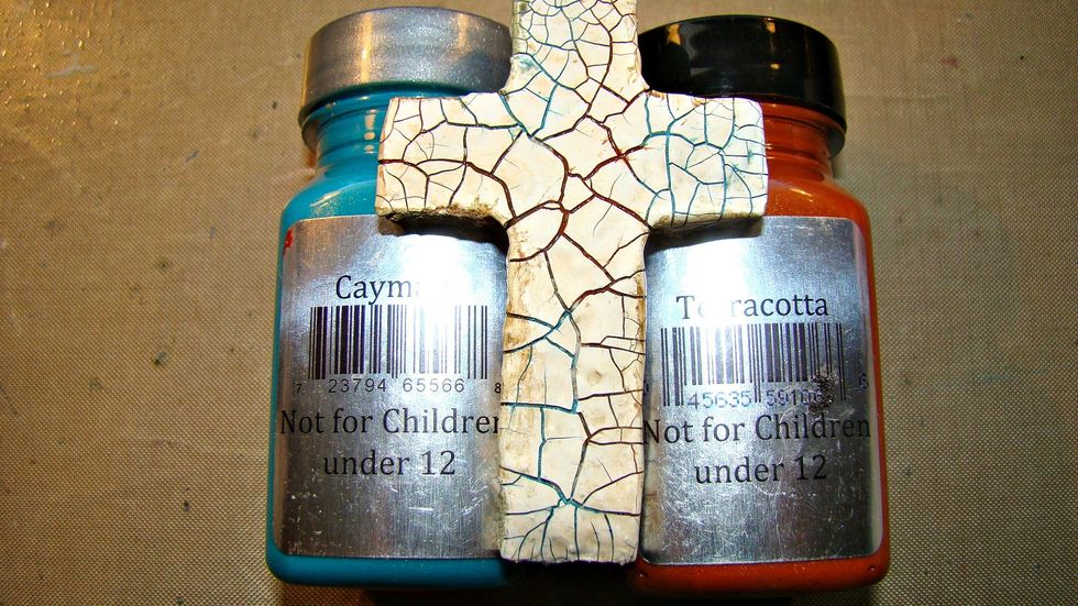 Once your cross is nice and cracked paint the two following colors randomly on the cross allow to dry a bit and then wipe off. The paint gets in the recess portion of the cracks for a nice effect.