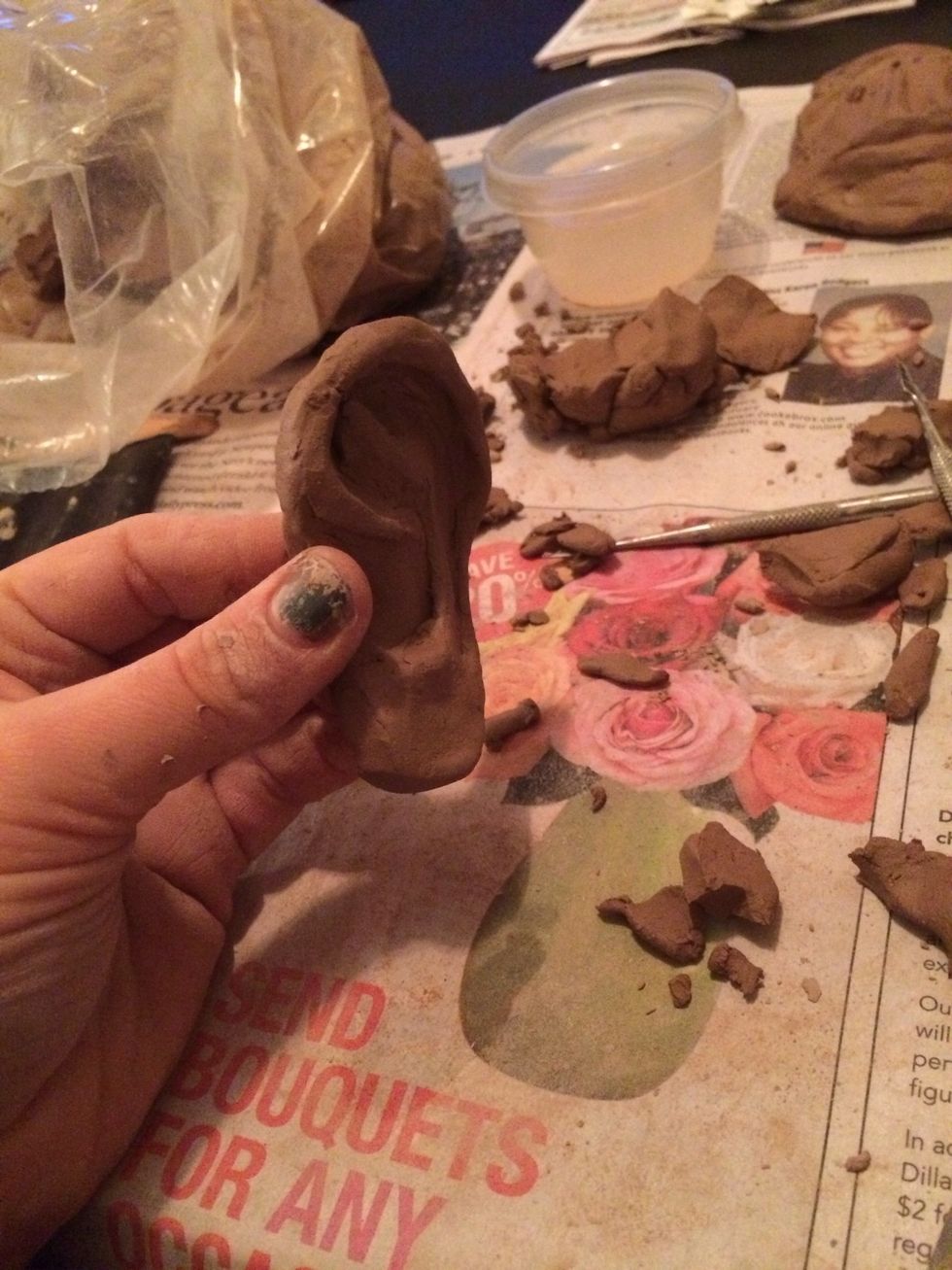 Once your details are completed, carefully hold the side of the ear that will attach to the head and push the cartilage of the ear slightly back. Now when the ears are attached they won't stick out.